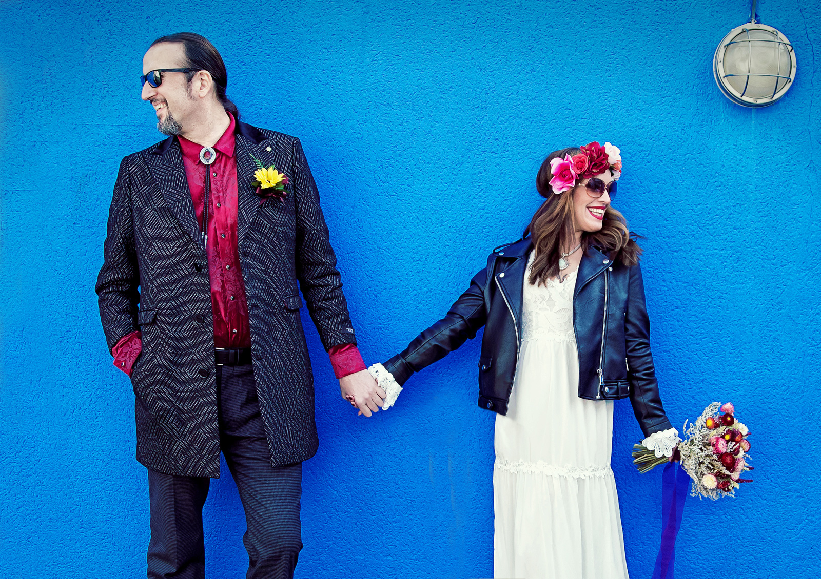 Islington-bride-and-groom-hand-in-hand-by-blue-wall-image (listing)