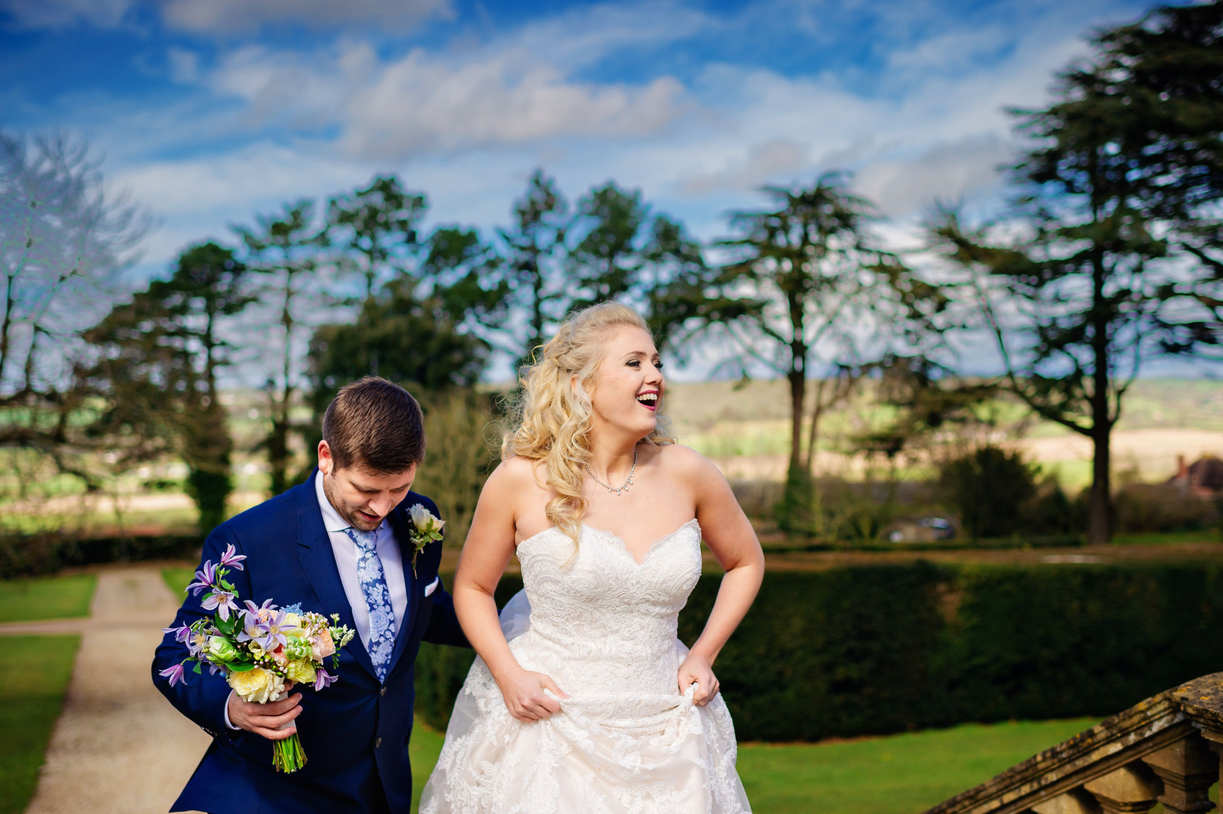 A cheap wedding photographer capturing laughter of a bride and groom at a country house in London. (listing)