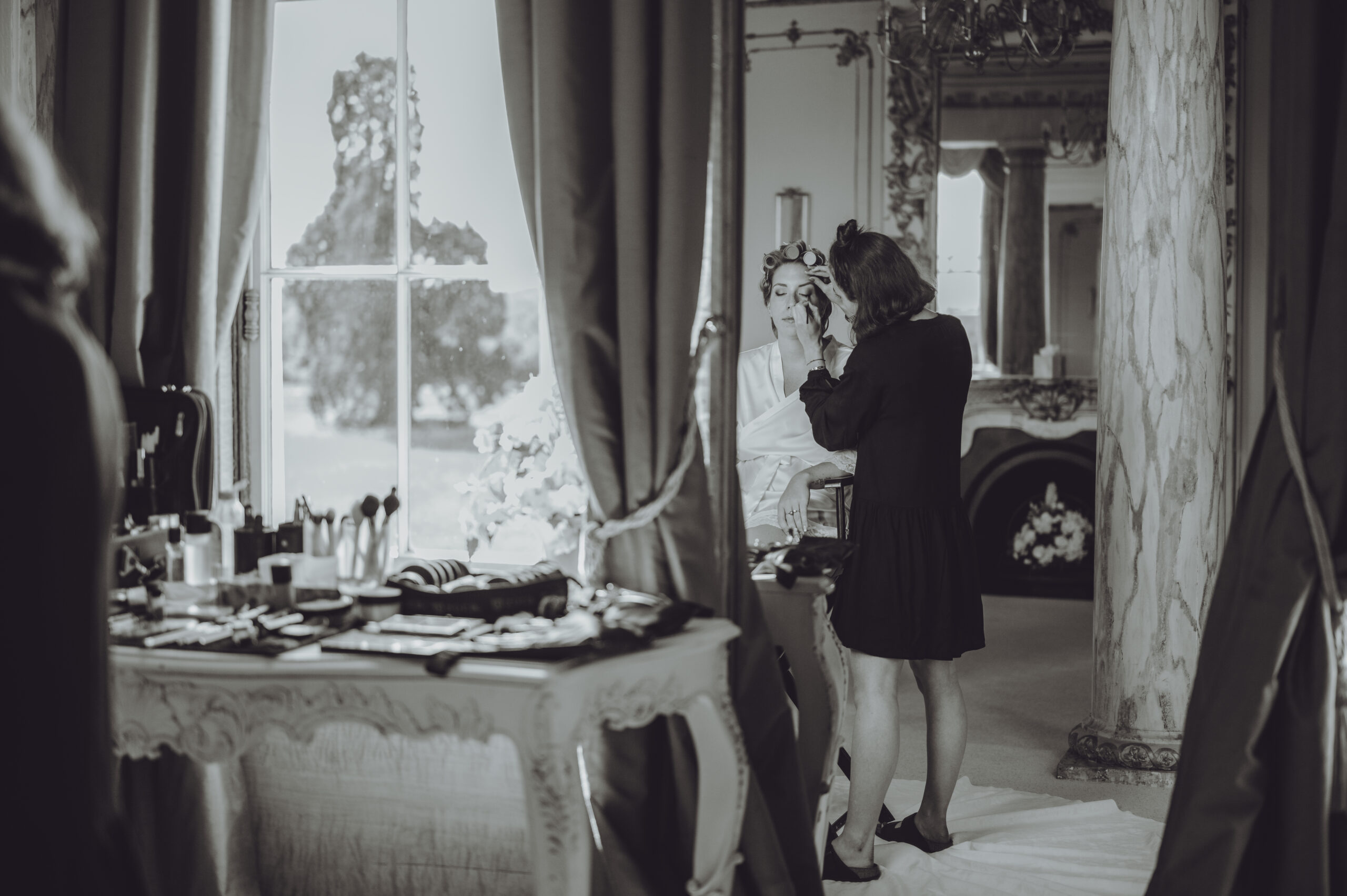 A woman is getting ready in front of a window. (listing)