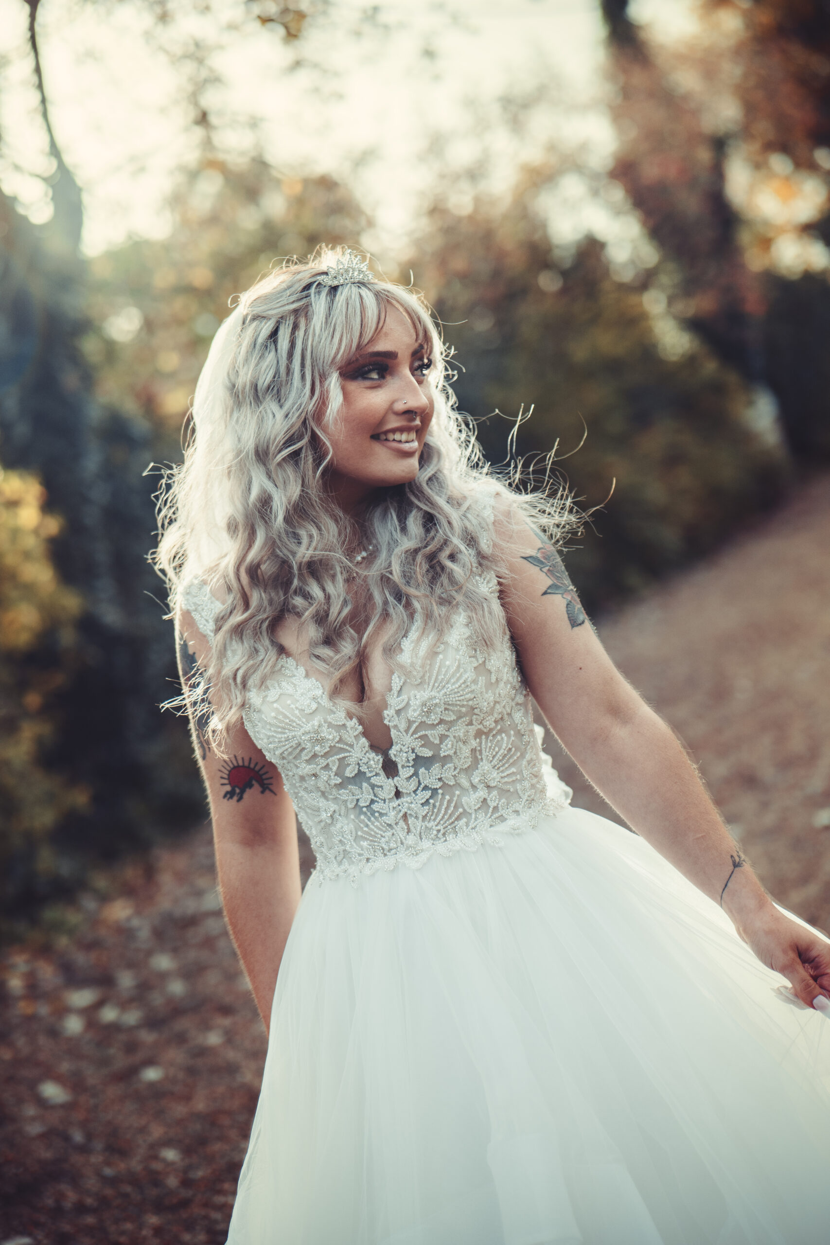 A bride in a wedding dress walking down a path. (listing)
