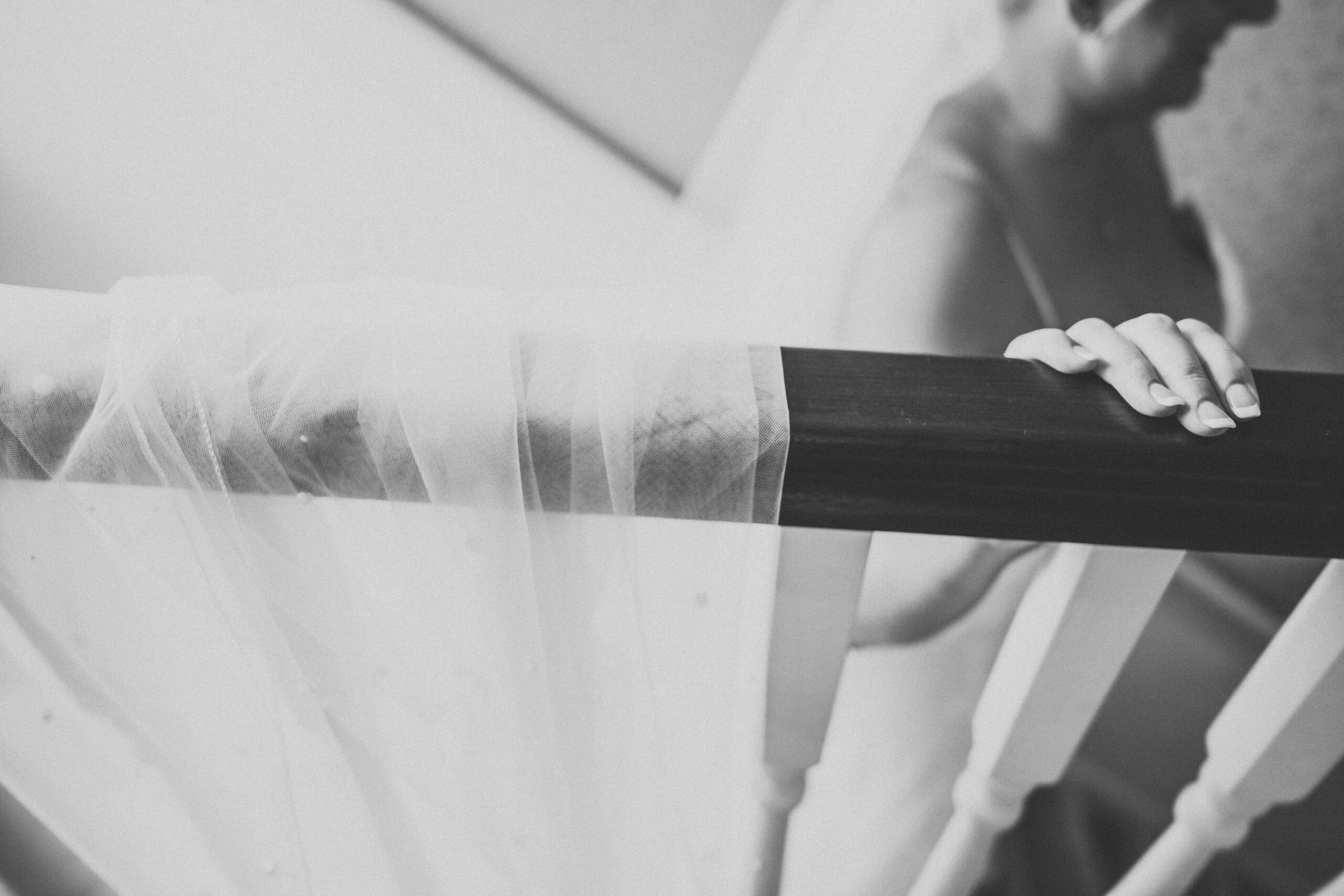 A bride is holding her veil on a staircase. (listing)