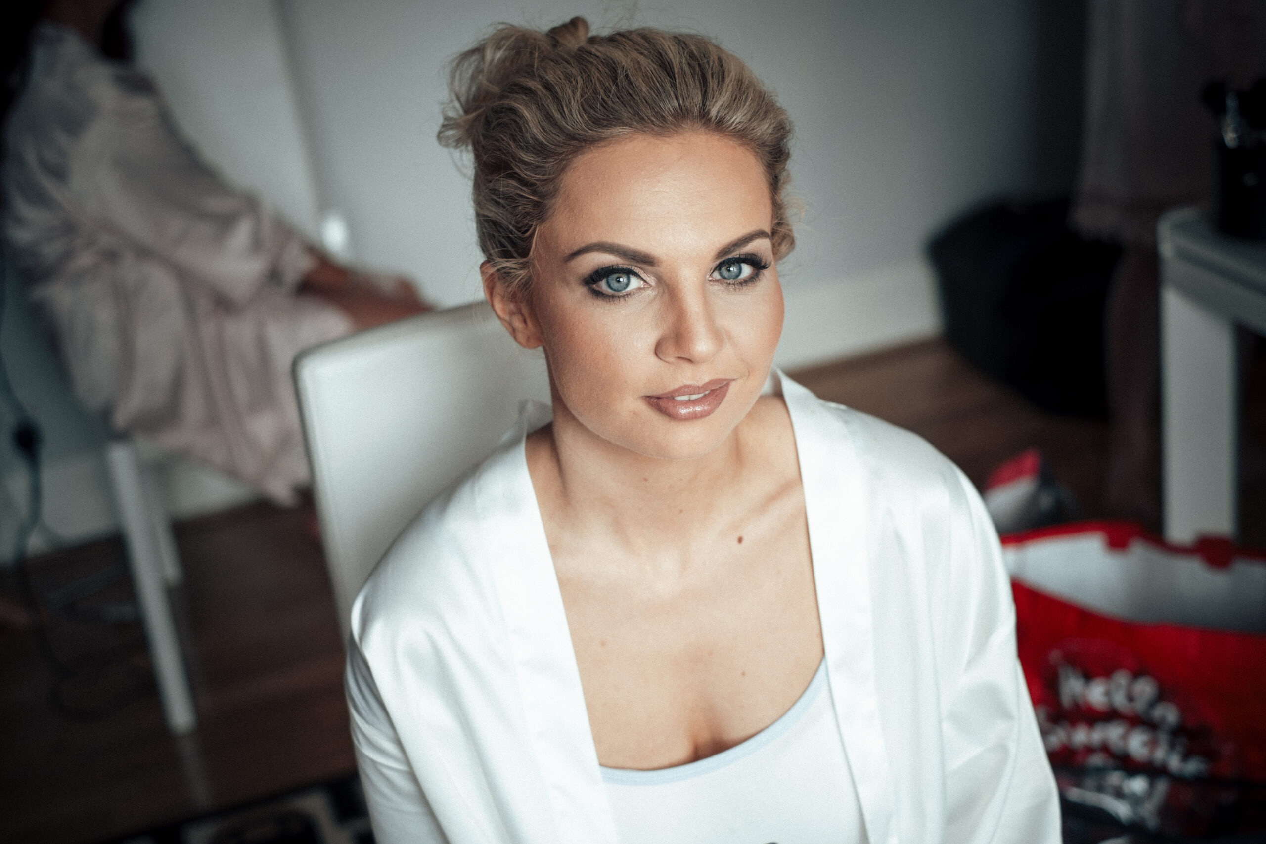 A woman in a white robe is posing for a photo. (listing)