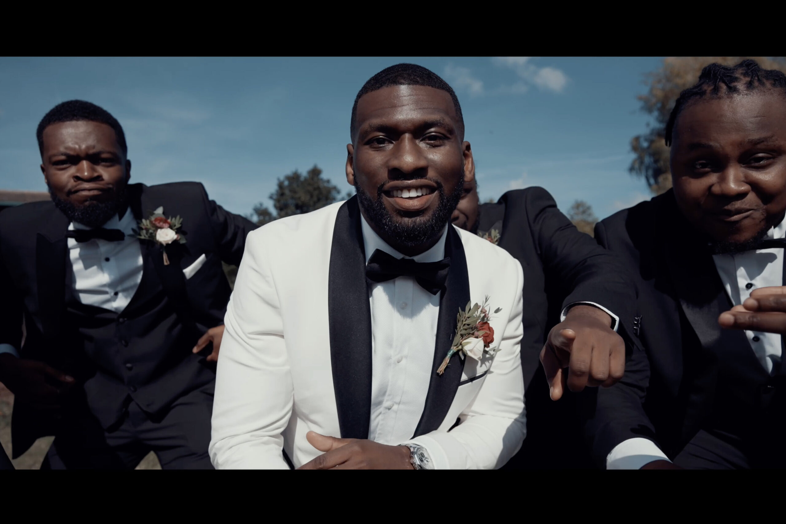 A group of men in tuxedos posing for a picture. (listing)