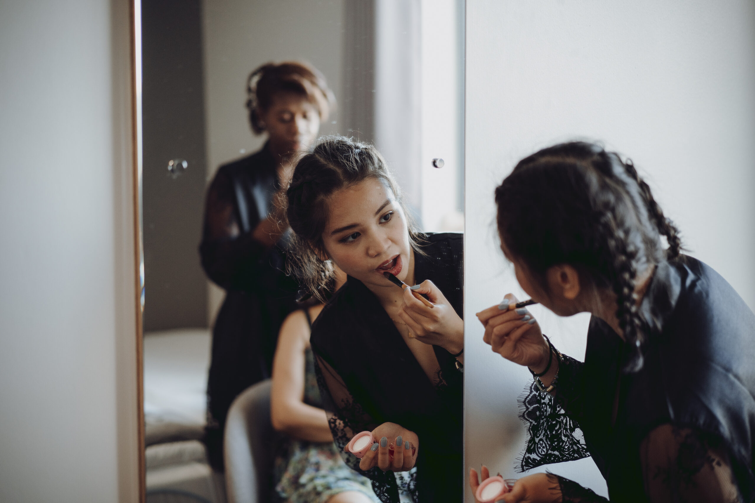 A bride getting ready in front of a mirror. (listing)