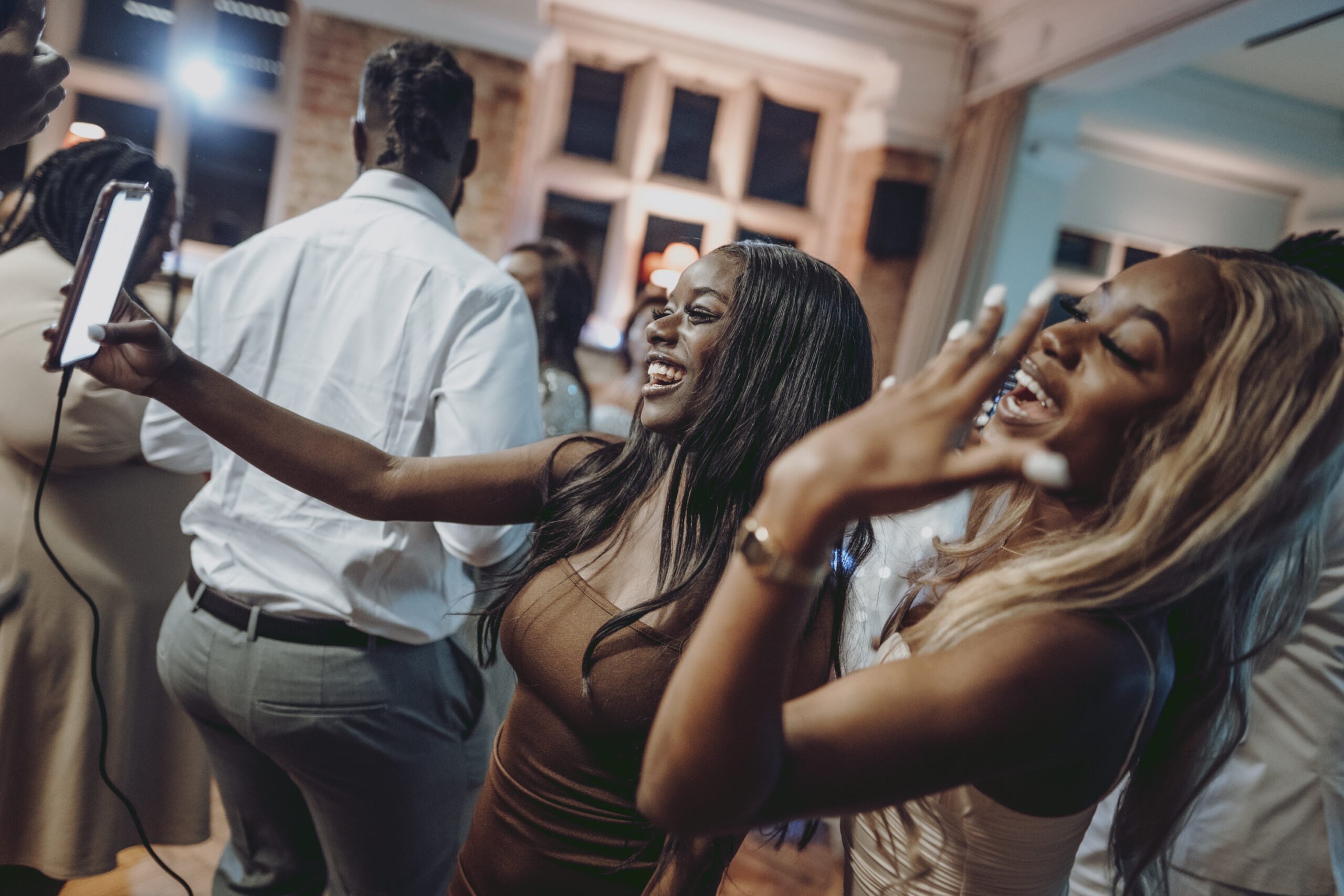 A group of people taking a selfie at a party. (listing)