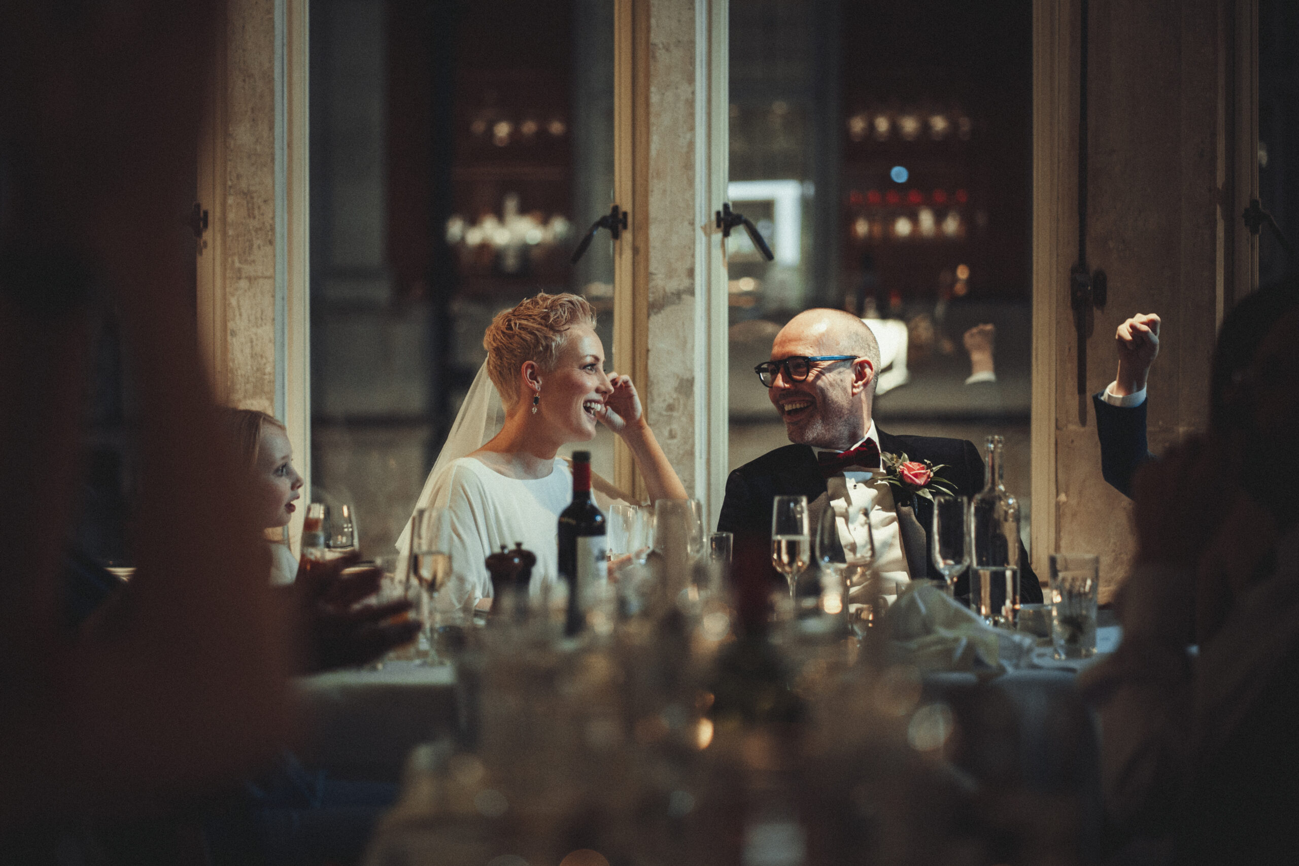 A bride and groom clapping at a wedding reception. (listing)