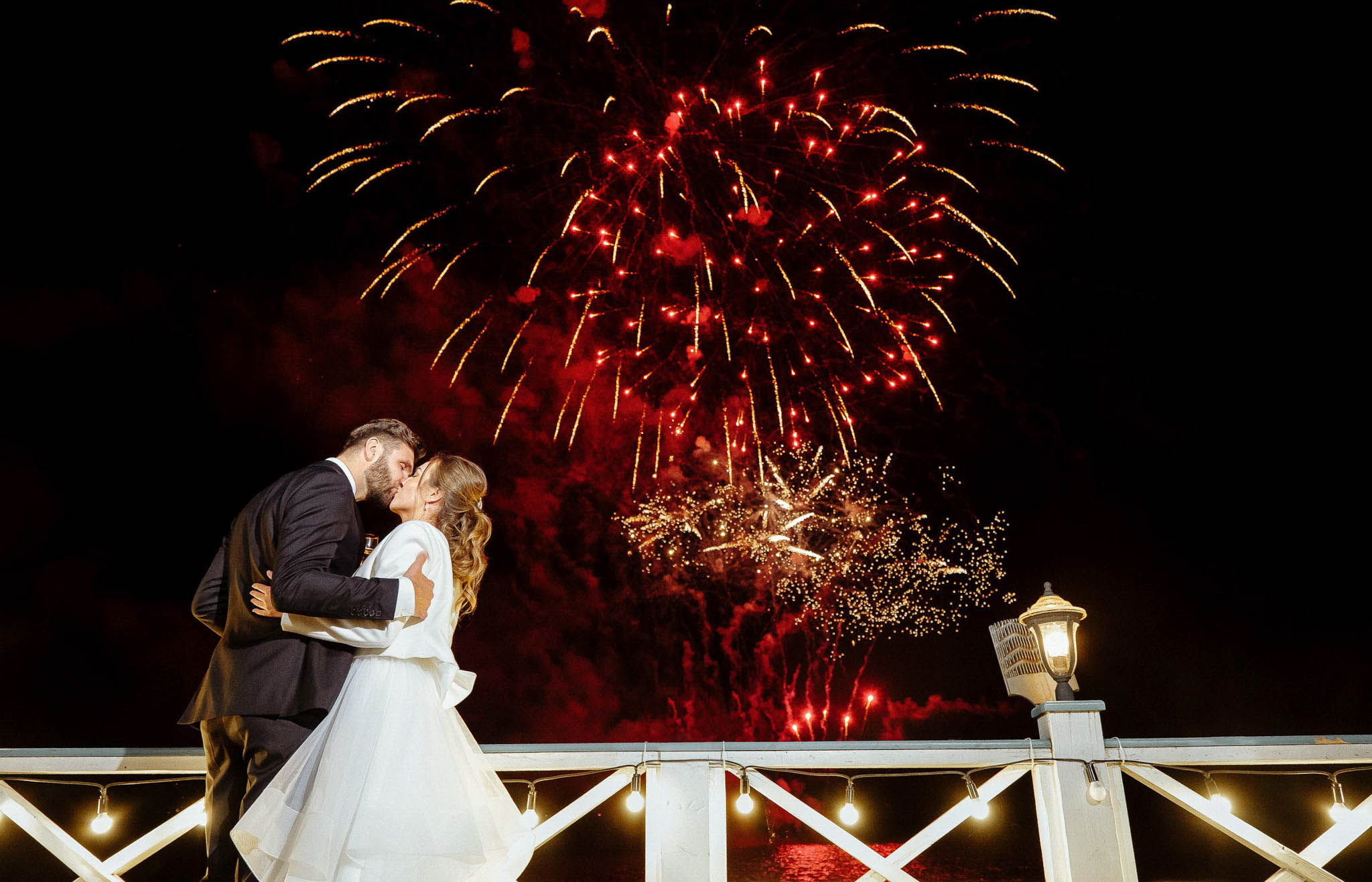 Bride and Groom's Romantic Kiss Under Fireworks